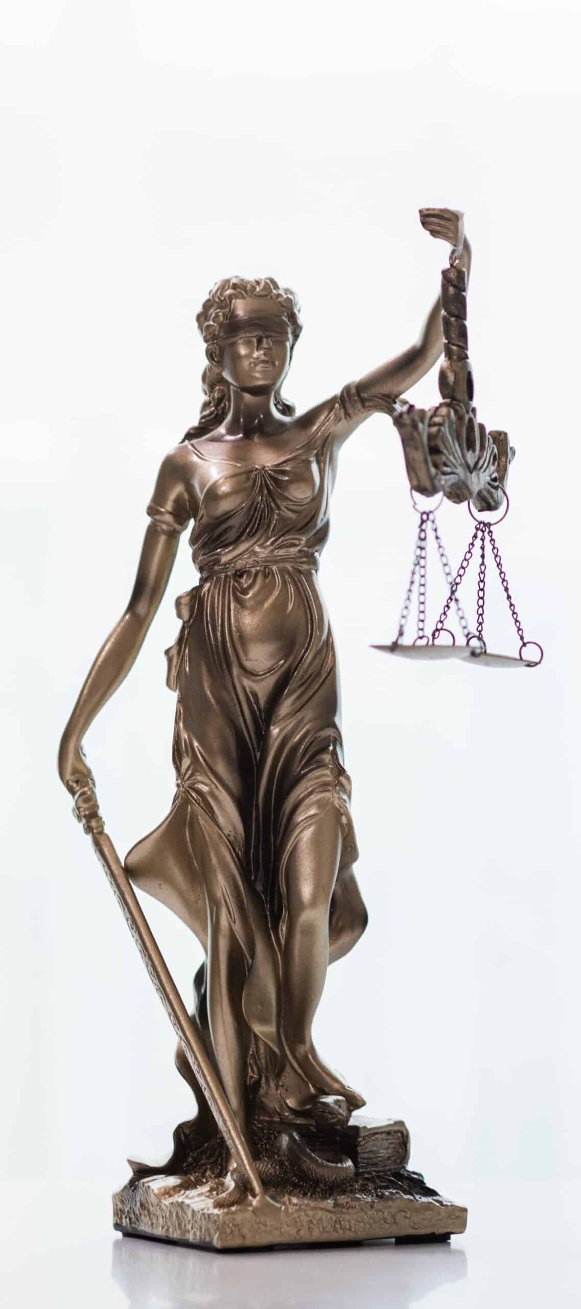 Statue of Lady Justice holding scales and sword symbolizing law and fairness. Statue of Lady Justice holding scales and sword symbolizing law and fairness.